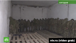 A screenshot from the March 2022 report by the Kremlin-loyal Russian television network NTV shows Ukrainian soldiers being held at the filtration camp in Naroulya, Belarus.