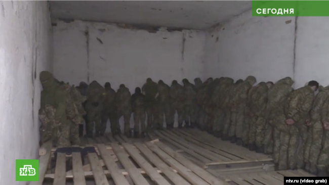 A screenshot from the March 2022 report by the Kremlin-loyal Russian television network NTV shows Ukrainian soldiers being held at the filtration camp in Naroulya, Belarus.