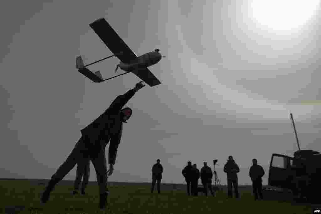 A Ukrainian serviceman launches an unmanned reconnaissance aircraft near the eastern Ukrainian city of Lysychansk in the Luhansk region on March 24. (AFP/Petro Zadorozhnyy)