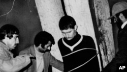 An Iranian military police sergeant is tied to a tree for execution by a revolutionary committee firing squad in Qazvin, Iran, March 3, 1979.