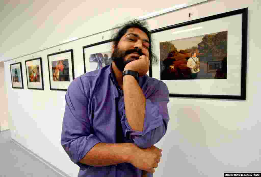 Bihari poses in front of his photographs at an exhibition in Ostrava, Czech Republic.