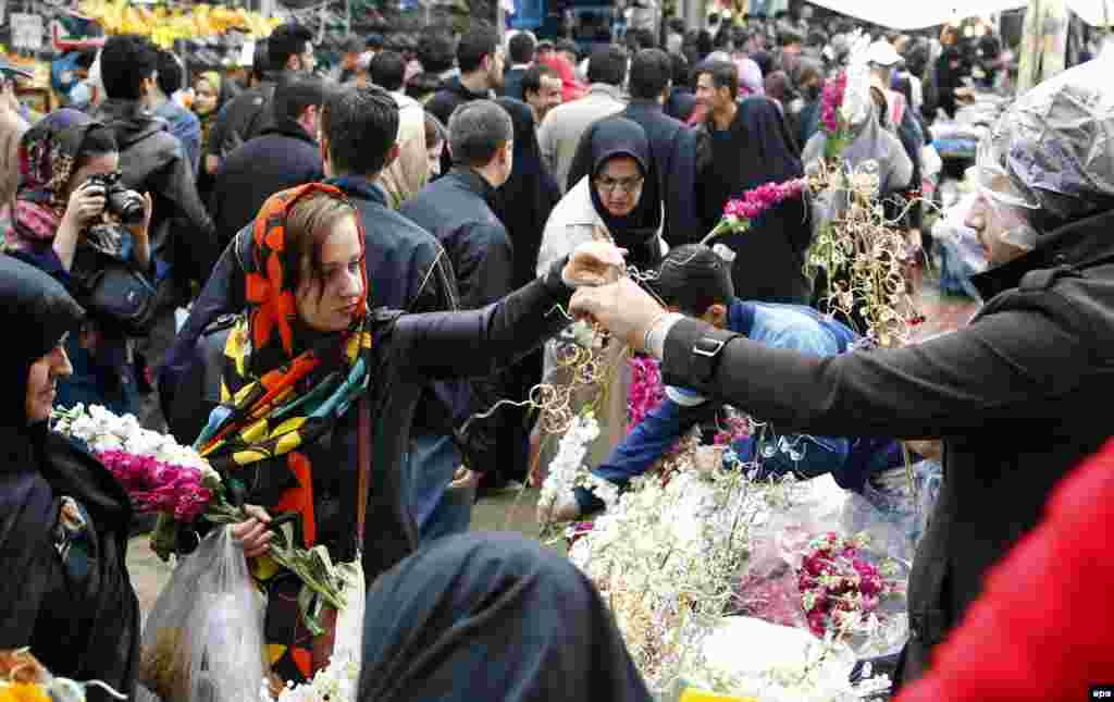 Iranians buy flowers for Norouz celebrations at a street market in Tehran.