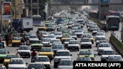 A picture taken on September 12, 2015 shows Iranians driving in heavy traffic in the capital Tehran.