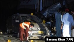 Pakistani security officials examine the site of a bomb blast in Quetta, the capital of Balochistan, on May 13.