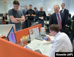 Russian President Vladimir Putin visits the headquarters of Yandex, Russia's largest search engine, in Moscow in September 2017.