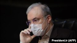 Iranian Health Minister Saeed Namaki wears a protective mask during a cabinet session in the capital Tehran, March 25, 2020