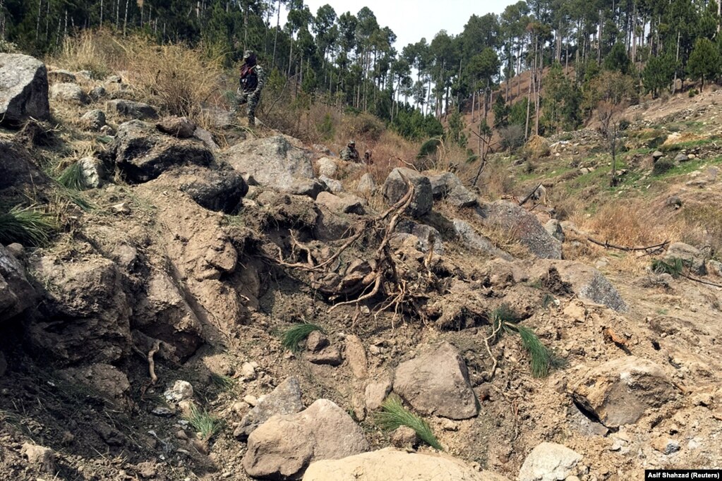 A Pakistani soldier near a crater allegedly left by an Indian air strike in Pakistan's Balakot region. Photo taken on February 28.