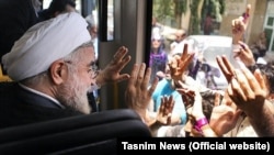 Hassan Rohani greets supporters