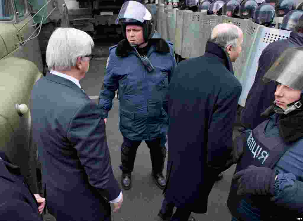 Kiyev 20 fevral 2014 Almaniyanın xarici işlər naziri Frank-Walter Steinmeier (solda) və onun fransalı həmkarı Laurent Fabius (sağda) prezident Yanukovych-lə görüş üçün silahlı əsgərlərin kordonunu keçirlər