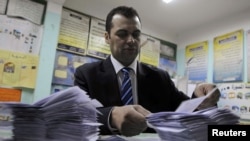 An Egyptian official counts ballots after polls closed in a 2012 vote.