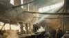 Workers prepare lunch in the ancient kitchen of Kabul University. (photos by Grant Podelco)