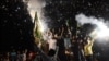 Supporters of Nawaz Sharif celebrate with fireworks in Lahore on May 12.