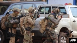 French special forces take position in the surroundings of the Splendid hotel following an attack by Al-Qaeda linked gunmen on January 16 in Ouagadougou.