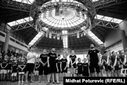 Members of the Spid swim club stand for the national anthem during an international competition