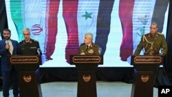  Iran's Chief of Staff of Armed Forces, Maj. Gen. Mohammad Hossein Bagheri, left, speaks during a press conference with Syria's defense minister Gen. Ali Ayoub, center, and Iraqi army commander, Gen. Osman Ghanemi in Damascus, Syria, Monday, March 18, 201