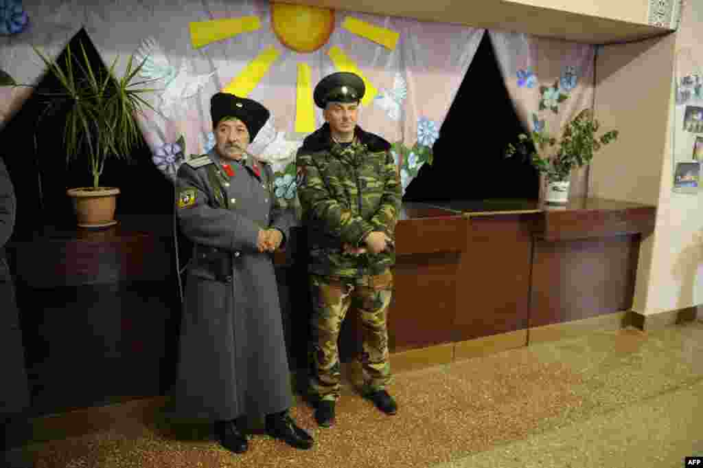 Pro-Russian militants at a polling station in Novoazovsk, in the eastern Donetsk region, on November 2 (AFP/Alexander Khudoteply) 