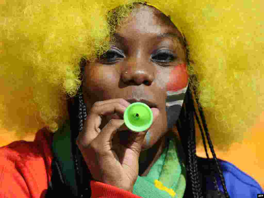 A South African soccer fan blows a mini vuvuzela before the opening ceremony of the 2010 FIFA World Cup in Johannesburg on June 11. Photo by AFP