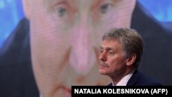 RUSSIA – Kremlin spokesman Dmitry Peskov sits in front of a screen displaying Russian President Vladimir Putin addressing his annual press conference via a video link. Moscow, December 17, 2020 