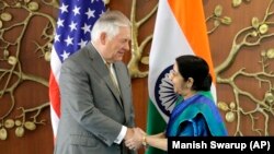 Indian Foreign Minister Sushma Swaraj (right) greets U.S. Secretary of State Rex Tillerson in New Delhi on October 25. 