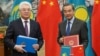 Kazakh Foreign Minister Beibut Atamkulov (left) and Chinese Foreign Minister Wang Yi attend a signing ceremony at the Diaoyutai State Guesthouse in Beijing on March 28.