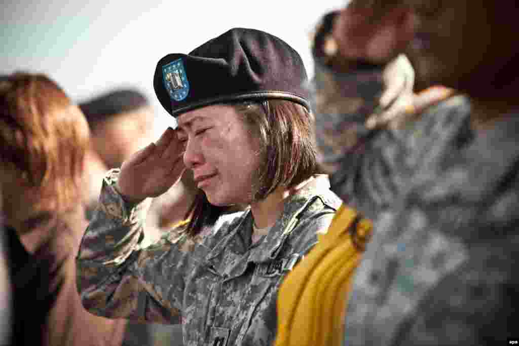 A U.S. soldier cries at a memorial service for the victims of a mass shooting at Fort Hood, Texas. On November 5, 2009, Nidal Hasan, a U.S. army major and psychiatrist, shot dead 13 people and injured 32 others at the military base. He was captured, tried by a military court, and sentenced to death by lethal injection. The case is currently under review by appellate courts.