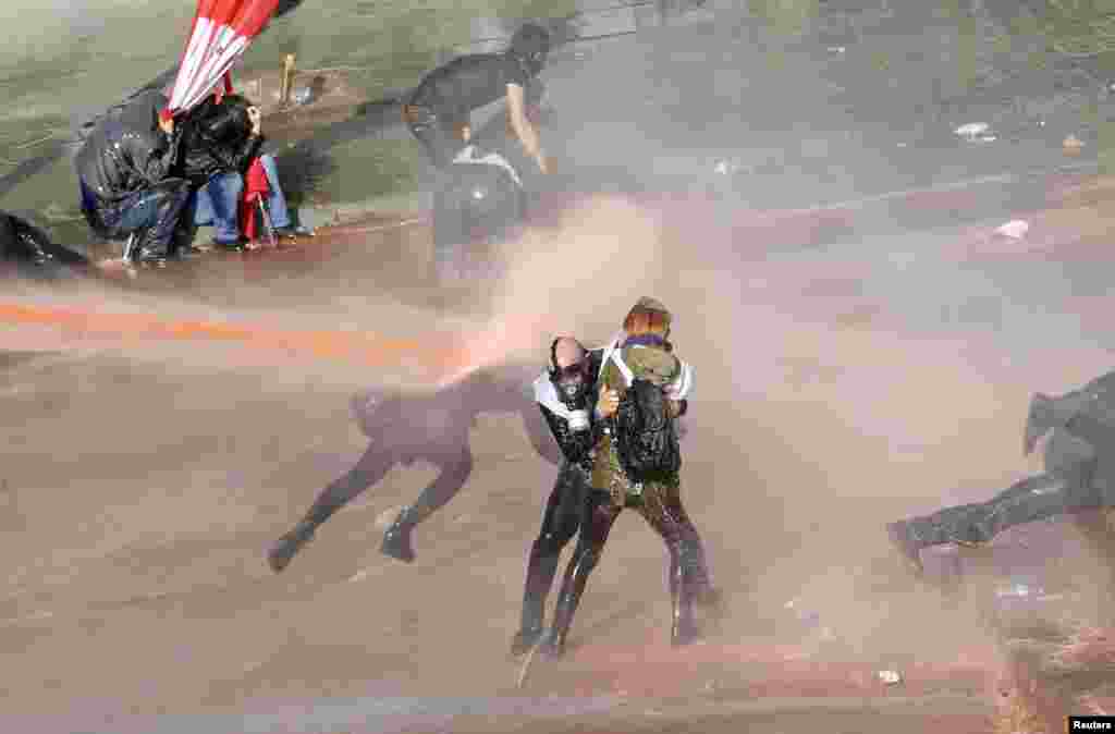 Turkish riot police use tear gas and water cannon to disperse protesters as they try to march to the parliament during an antigovernment protest in Ankara on February 13. (Reuters/Umit Bektas)