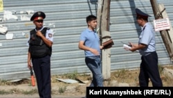 "Терроризмге қатысы болуы мүмкін 5 күдікті жойылған" оқиға орнында жүрген полицейлер. Алматы облысы, Қарасай ауданы, 17 тамыз 2012 жыл.