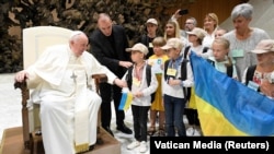 Pope Francis meets Ukrainian refugees as he holds his weekly general audience at the Vatican on August 24, 2022.
