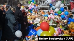 People visit a makeshift memorial to victims of a shopping mall fire in Kemerovo in western Siberia in March 2018. 