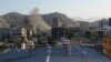 Smoke rises from a building during an ongoing attack between Afghan security force and a suicide bomber in the Shahr-e-Naw area in Kabul on May 9.