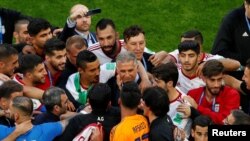 Soccer Football - World Cup - Group B - Morocco vs Iran - Saint Petersburg Stadium, Saint Petersburg, Russia - June 15, 2018 Iran coach Carlos Queiroz celebrates after the match with players REUTERS/Lee Smith