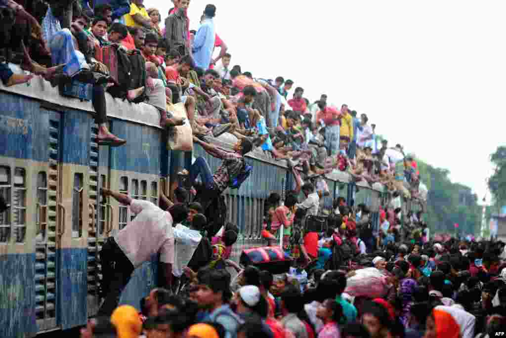 Bangladeshis cram onto a train in Dhaka as they rush home to their respective villages to be with their families ahead of the Muslim festival of Eid al-Fitr. (AFP/Munir uz Zaman)
