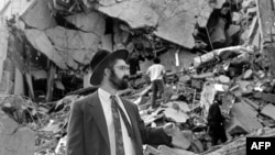A man walks over the rubble left after a bomb exploded at the Argentinian Israelite Mutual Association in Buenos Aires in July 1994, killing 85 people and injuring about 300 others in the worst attack of its kind in the South American country.