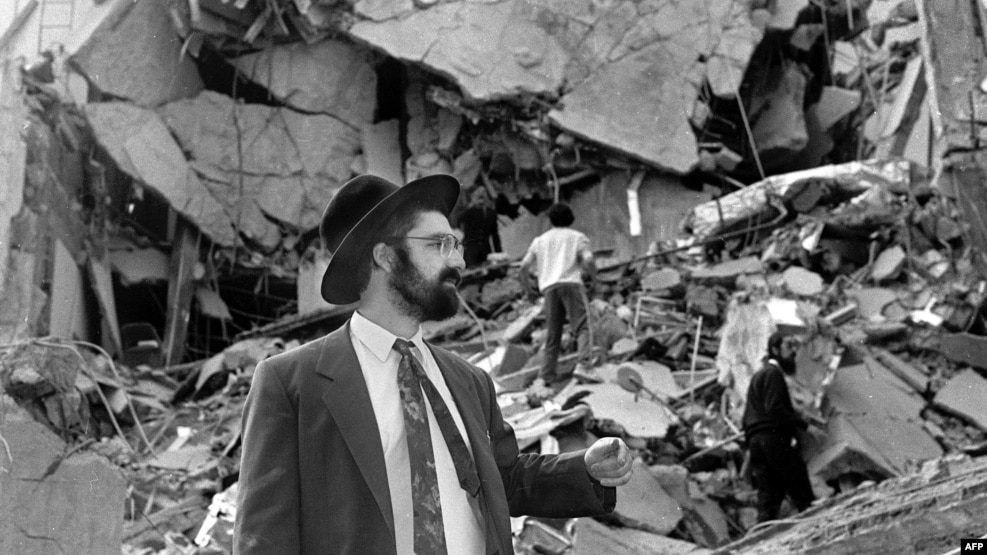 A man walks over the rubble left after a bomb exploded at the Argentinian Israelite Mutual Association in Buenos Aires in July 1994, killing 85 people and injuring about 300 others in the worst attack of its kind in the South American country.