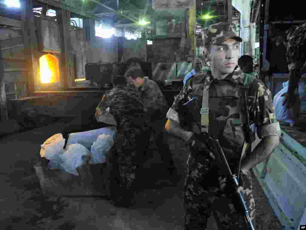 Uzbek National Security Service officers prepare confiscated drugs so that they can be destroyed at a plant on the outskirts of the country's capital, Tashkent, on June 24.Photo by Anvar Ilyasov for AP