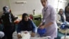 A midwife helps a mother with her newborn baby at the Razai Foundation Maternity Hospital in Herat. In Afghanistan, not having a son can doom a mother's marriage.