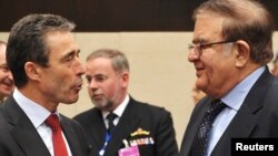 NATO Secretary-General Anders Fogh Rasmussen (left) speaks with Afghan Defense Minister Abdul Rahim Wardak at NATO Headquarters in Brussels on March 11.