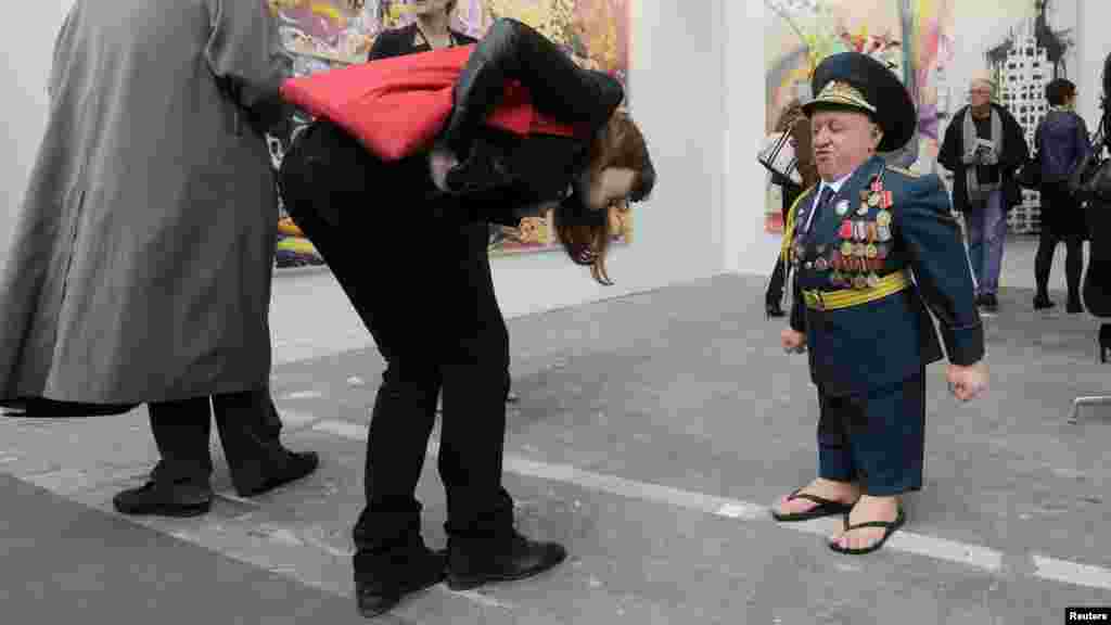 OCTOBER 17, 2012 -- A visitor looks at an exhibition titled &quot;Soviet Suprem 2012&quot; by artist Gilles Barbier during the International Contemporary Art Fair at the Grand Palais in Paris. (Reuters/Jacky Naegelen)