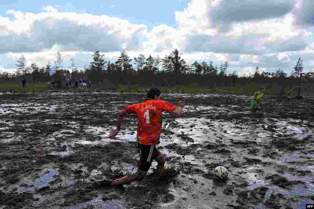 A Russian swamp-football player kicks the ball during the Russian Swamp Football Cup outside of St. Petersburg. (AFP)