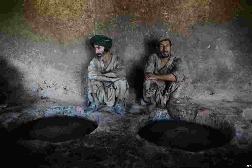 Afghan laborers rest as they work at a leather factory in the Tashqurghan district on the outskirts of Mazar-e Sharif. (AFP/Farshad Usyan)