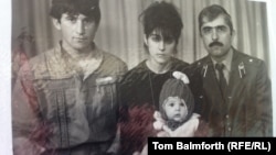 A family photo: Anzor Tsarnaev (left), Zubeidat Tsarnaeva, and Anzor's brother Mukhammad Tsarnaev in an undated photo. They are holding young Tamerlan Tsarnaev.