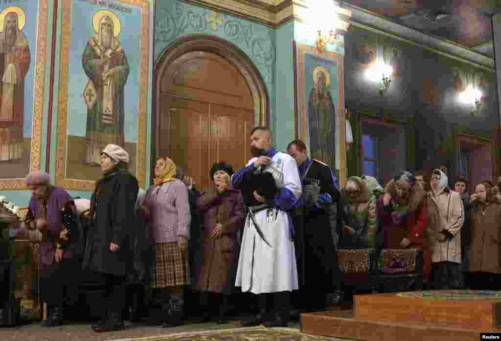 In Russia, Orthodox believers attend a service on the eve of Orthodox Christmas in Kazan Cathedral in Volgograd.