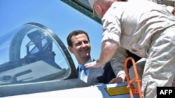 Syrian President Bashar al-Assad sits inside a Sukhoi Su-27 jet during his visit to the Russian air base at Hmeimim on June 27.