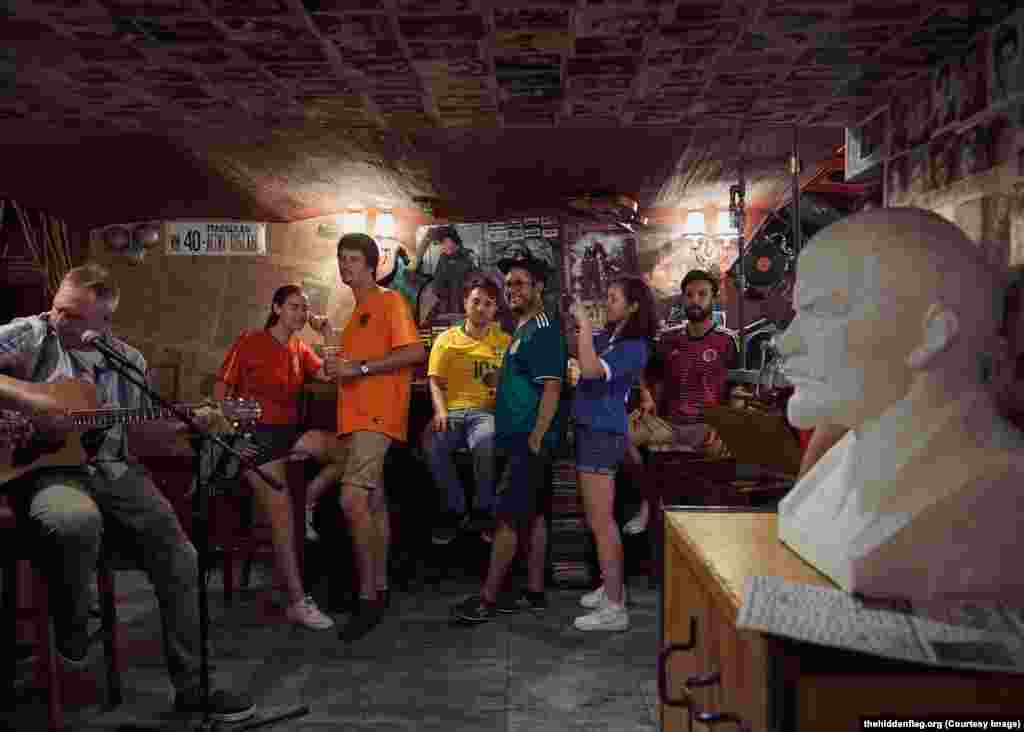 The group in a bar next to a bust of Lenin. Brazilian Eloi Pierozan Junior (in yellow) says his boyfriend warned him of the danger of protesting gay rights in Russia, but says &ldquo;I&rsquo;m not worried about the risk, it&rsquo;s a project that I really want to be involved in.... It&rsquo;s a call to love.&rdquo;