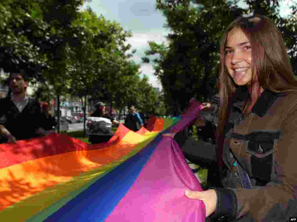 Activists hold a rainbow flag, the symbol of the gay rights movement, as they march through Moscow on May 29. The gay pride parade took place for the first time in the Russian capital without arrests or violence by counterprotesters. Photo by Andrey Smirnov for AFP