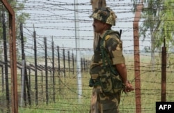 An Indian border guard keeps watch near the line of control in the disputed Kashmir region.