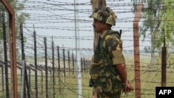 An Indian border guard keeps watch near the line of control in the disputed Kashmir region. 
