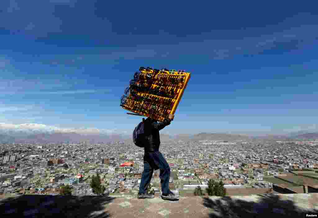 A man carries sunglasses for sale during Afghan Norouz celebrations in Kabul. (Reuters/Mohammad Ismail)