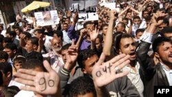 A Yemeni man shows the palms of his hands with the words "go out" written on them during a protester in Sanaa on February 13.