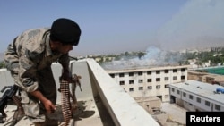 Smoke billows from the roof of a government building that the Taliban took over during clashes in Kandahar in 2011.